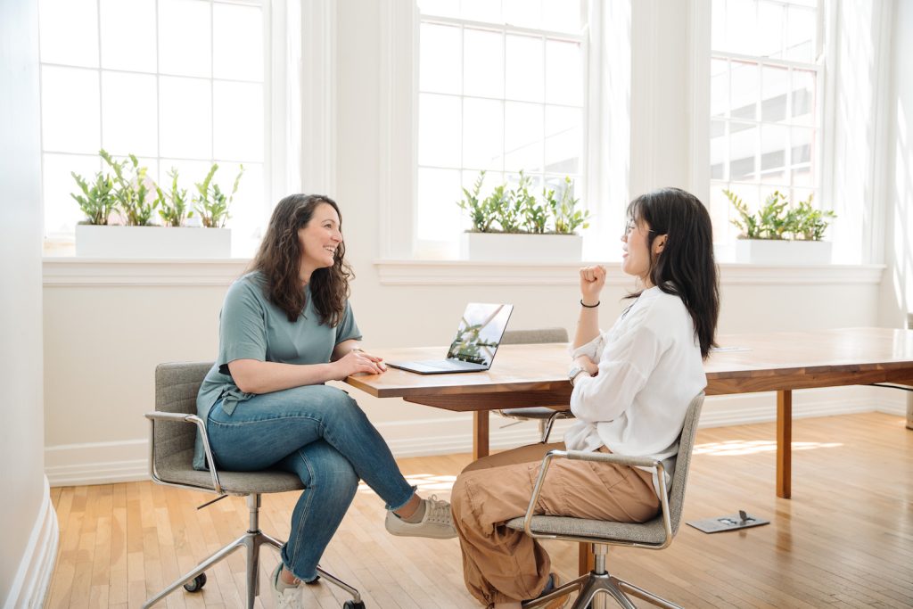 Startup employees working in 4th floor conference room